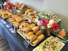 an assortment of sandwiches and salads on a table at a buffet or party event