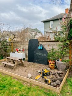 Nature play area with chalkboard, mud kitchen, construction zone and Dino habitat Toddler Garden Ideas, Nature Play Area, Sensory Gardens, Backyard Play Spaces, Outdoor Kids Play Area, Outdoor Play Space, Play Area Backyard