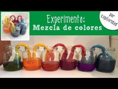 there are many different colors in the glass bottles on the counter and behind them is a sign that says experimento mezcla de coleres