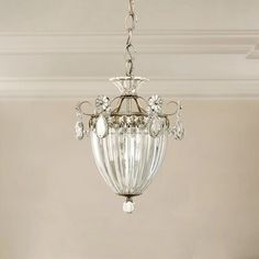 a crystal chandelier hanging from a ceiling in a room with white walls and ceilings