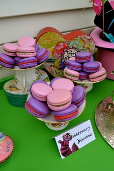 colorful macaroons and cupcakes are on display at a party or celebration