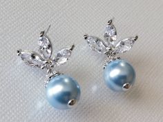 Wedding Light Blue Blush Blue Pearl Cubic Zirconia Leaf Silver Bridal Earrings. PLEASE READ ITEM DESCRIPTION and SHOP POLICIES before placing your order, and contact me with any questions! EARRINGS are about 1.02 inch (2.6cm) long from top of earring stud to bottom. MATCHING NECKLACE: https://www.etsy.com/listing/1259614370/blue-pearl-wedding-necklace-light-blue?click_key=e6cfa35919e60ef5e93ed4453dc1a5de99a0b1fd%3A1259614370&click_sum=88721426&ref=shop_home_active_22&sca=1&sts=1 BRIDAL EARRINGS Blue Bridal Earrings For Formal Occasions, Blue Pearl Drop Earrings For Formal Occasions, Formal Blue Pearl Drop Earrings, Blue Pearl Drop Bridal Earrings As Gift, Blue Pearl Drop Earrings For Party, Blue Pearl Drop Bridal Earrings For Wedding, Light Blue Drop Earrings For Wedding, Blue Dangle Bridal Earrings With Pearl Drop, Wedding Light Blue