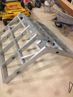 a metal frame sitting on top of a floor next to other tools and construction equipment