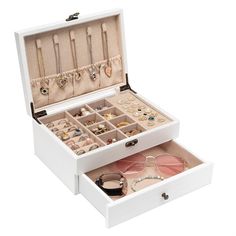 an open white jewelry box filled with lots of different items