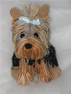 a small stuffed dog with a bow on it's head