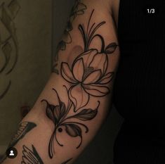 a woman's arm with flowers and birds on it