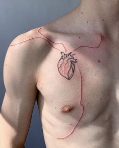 a man with a heart tattoo on his chest