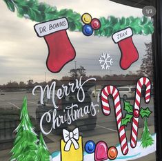 a decorated window with christmas decorations and candy canes