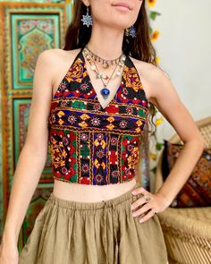 These beautiful tops are made from Indian Kutch embroidered fabric, decorated with mirrors. They have ties around the neck and 3 at the back to adjust the fit. These tops are Fair Trade and made in India, where the artisans are provided with the fair working conditions and wages we believe they deserve. Available in size One Size (fits UK 8-14 comfortably). Beautiful Tops, Lehenga Blouse Designs, Lehenga Blouse, Jumpsuit Jacket, The Fair, Embroidered Fabric, Halter Crop Top, Bridal Lehenga, Dress Trousers