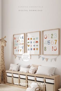 a baby's room with white walls and pictures on the wall