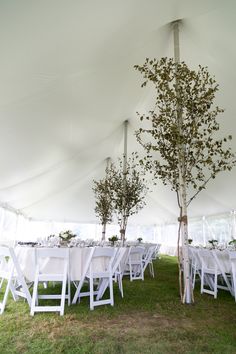 an outdoor tent with tables and chairs set up