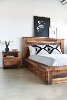 a bedroom with a bed, nightstands and pictures on the wall