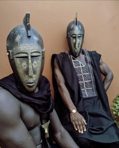 two african men sitting next to each other