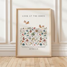 a framed poster with the words look at the birds written in floral designs on it