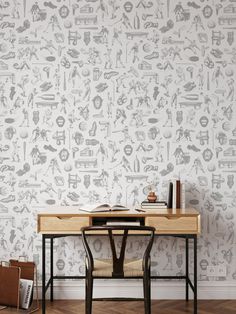 the wallpaper in this room has many different things on it, including a desk and chair