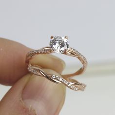 a person holding a diamond ring in their hand