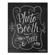 a chalkboard sign that says photo booth grab a strike and pose