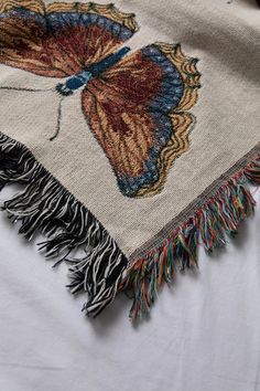 This woven throw blanket features a collection of boho-inspired butterflies decorated allover. It's broad spectrum of pastel colors intricately woven together makes a statement in any room. Trimmed with multicolor fringed edges. Content + Care- 100% Cotton- Machine Wash, Cold Cycle, Mild Detergent, Do Not Bleach; Tumble Dry Low Heat- Made in the USA Size- Dimensions: 37”W x 52”L- Dimensions: 50”W x 60”L- Dimensions: 60”W x 80”L Boho Butterfly, Woven Throw Blanket, Woven Throw, Pastel Colors, Throw Blanket, Room Decor, Quick Saves