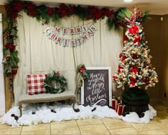 a decorated christmas tree in the corner of a room with decorations on it and a sign that says merry christmas