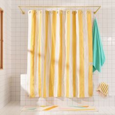 a yellow and white shower curtain in a bathroom