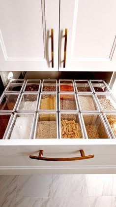 an open drawer in a kitchen filled with lots of different types of spices and seasonings