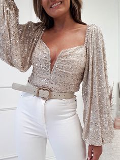 Get Christmas Party ready with our stunning Astria Sequin Top. This top is finished in super sparkly sequins and its long puffy sleeves give it a glamorous look. Exclusive to Oh Hello Clothing Exclusive Colour: Beige sequin Fabric: Stretchy 90% polyester 10% spandex Sizing: True to size Model wears: Size small = UK 8 Model height: 5ft 3 Sleeve length: 64cm Care: Gentle hand wash Shimmer Tops For Women, Trendy Long Sleeve Sequin Top, Festive Shimmer Tops, Trendy Long Sleeve Glitter Top, Festive Long Sleeve Sequin Top, Elegant Beige Sequined Tops, Oh Hello Clothing, Puff Sleeves Blouse, Gold Sequin Top