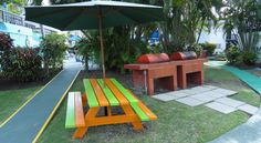 an orange and green picnic table next to some benches