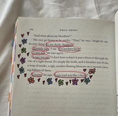 an open book with some writing on the page and hearts drawn in red, green, blue, yellow and pink