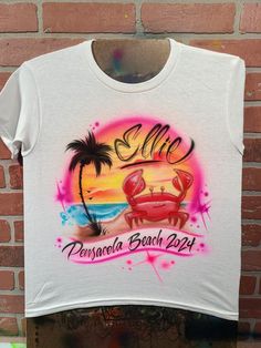 We create custom airbrush t shirts with your design. Personalize our air brush t shirts with your name and colors and we'll create a custom design just for you! 🔹 You can choose to have the design on the Front or Back of your item, and can add a name or short text to the opposite side for $10 more. We'll paint the additional name/text in a fitting style chosen by your artist. ⌚ Delivery Times typically Range from 1-2 weeks! If you need something be a specific date sooner than 2 weeks away, plea Y2k Style Custom Print T-shirt For Summer, Customizable White Sublimation Design For Summer, White Custom Print Summer T-shirt, White Custom Print Beach Shirt, Airbrush Shirt Ideas, Air Brush T Shirt, Air Brush Shirts, Customizable Fun Summer T-shirt, Summer Beach T-shirt With Custom Print