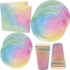 paper plates, cups and napkins are arranged in the shape of a rainbow tie dye pattern