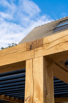 a close up of a wooden structure with sky in the background