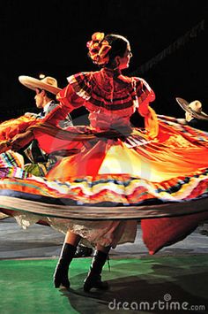 a woman is dancing in a colorful dress