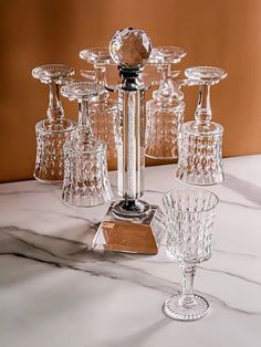 an assortment of crystal wine goblets on a marble table