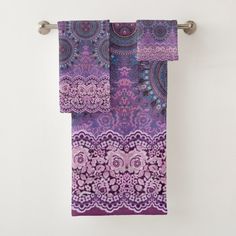 two purple towels hanging on a towel rack