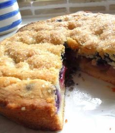 a blueberry pie cut in half on a plate