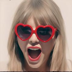 a woman with heart shaped sunglasses on her face making a funny face for the camera