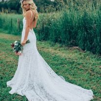 a beautiful blonde woman in a white dress holding a bouquet