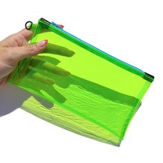 "One Transparent Neon Green Vinyl Sky Blue Zipper Pencil Case (with optional wristlet strap) You're going to want one of these zip cases in every color! They're perfect for carrying around and stashing your essentials: phone, cash and cards, keys, lip balm, sunscreen stick, ear buds, compact mirror, sunglasses, writing implements, knitting notions - there are so many possibilities! The attached d-ring makes it easy to clip a wristlet strap or key fob to these pouches. SIZE Approximately 4.5\" tall x 8\" wide (11.5cm x 20.5cm), not including d-ring FEATURES * 12 gauge transparent neon fluorescent green vinyl * sky blue zipper * black vegan faux leather zipper ends * small matte black d-ring * option to add a matching wristlet strap  This listing is for one green zip case, wristlet strap can Trendy Green Pouch Pencil Case, Trendy Green Pencil Case Pouch, Trendy Green Rectangular Pencil Case, Green School Pouch With Zipper Closure, Green Pouch Pencil Case With Zipper, Green Zipper Pouch For School, Green Pencil Case With Zipper Closure, Green Pencil Case With Zipper For Everyday Use, Green Pencil Case Pouch For Personal Use