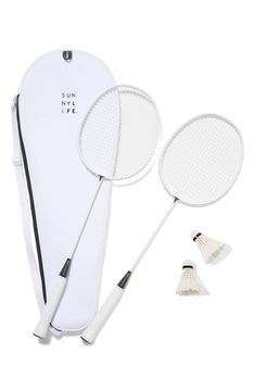 two badminton racquets and one paddle on a white background