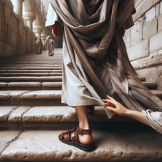 a man walking up some steps with his foot on the ground next to another person's hand