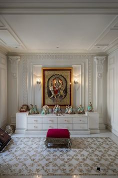 a living room with white furniture and a painting on the wall above it's mantle