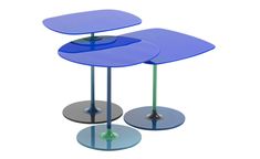 two blue tables sitting next to each other on top of metal bases with circular bases