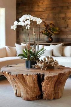 a wooden table with flowers on it in a living room