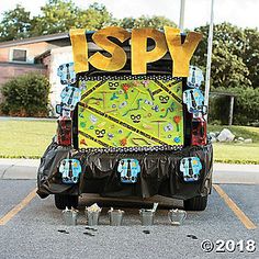 the back end of a vehicle with an advertisement on it that says spy in large letters