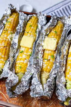 grilled corn on the cob with butter and parmesan cheese in aluminum foil