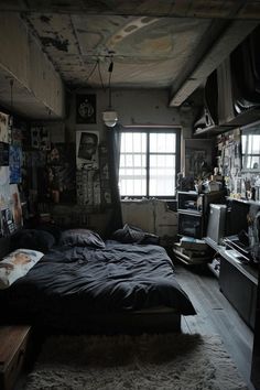 a bed sitting in the middle of a bedroom next to a window with lots of pictures on it