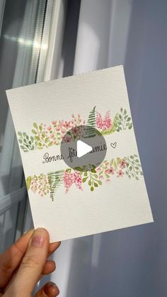 a person holding up a card with flowers on it and the words bonmin, kit mama