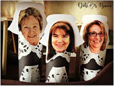 three women wearing black and white paper cups with their faces cut out to look like they are smiling