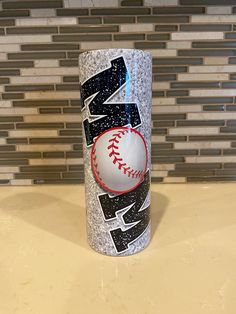 a can with a baseball on it sitting on a counter