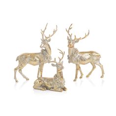 three gold deer figurines sitting next to each other